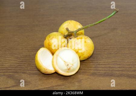 Baccaurea motleyana also known as lotkon isolate on wooden background. sweet and sour taste. Stock Photo