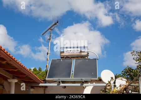 Sustainable warm water with natural thermal heating solar panels on a roof in Greece Stock Photo