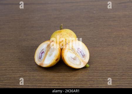 Baccaurea motleyana also known as lotkon isolate on wooden background. sweet and sour taste. Stock Photo