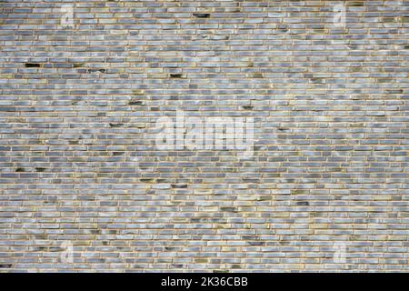 Background from a large wall made of gray bricks Stock Photo