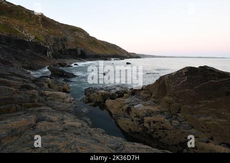 A rock pool at Tregardock Beach Cornwall before sunrise Stock Photo