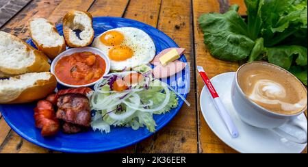 Two eggs sunny-side up with bacon, a full English breakfast served in Da Lat, Vietnam. Stock Photo