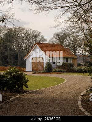 a small white house on the country side Stock Photo