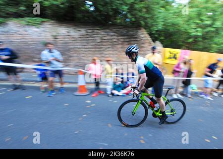 A cyclist straining as they race up Swains Lane in Highgate London during an Urban Hill