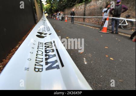 Perimeter Tape on the course of the Urban Hill Climb street racing event organised by the London Cycling Campaign, sponsored by Osbornes Law. The event is a flat-out race up the steepest street in London and alongside age and gender categories has competitions for folding and cargo bikes.  Swain’s Lane is the most famous and notorious climb in London. The lane is an extremely steep section of road, located in-between Hampstead Heath and Highgate Cemetery with a gradient that averages 9% over 0.6km, but increases to 14% near the top of the climb. Stock Photo
