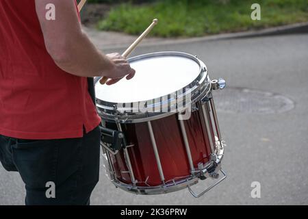 Mobile snare drum played in a marching band, musical percussion instrument for the rhythm at a parade on the street, selected focus, narrow depth of f Stock Photo