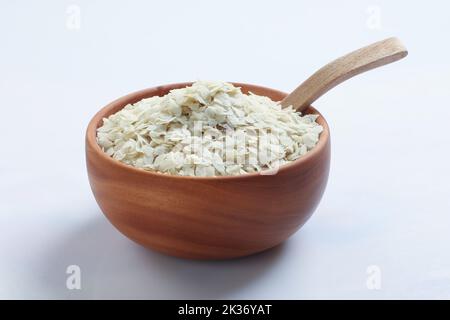 Raw Flattened Rice or Thick or thin Rice Flakes for Namkeen Chivda snacks or Aloo Poha for Indian Breakfast, served in a bowl. Stock Photo