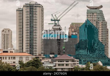 Bangkok, Thailand - 10 Sep 2022 : Architectural exterior view of Multiple skyscrapers and Building under construction site with cranes. Conceptual urb Stock Photo