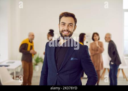 Portrait of smiling successful young businessman in office Stock Photo