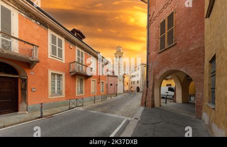 Fossano, Italy - September 23, 2022: Via Garibaldi with the colorful bell tower of the church of San Giorgio in the Borgo Vecchio district (old town) Stock Photo