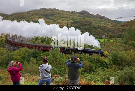Tourist photograph the Jacobite Steam Train, Glenifinnan Viaduct, Lochaber, Scottish Highlands, Scotland, UK Stock Photo
