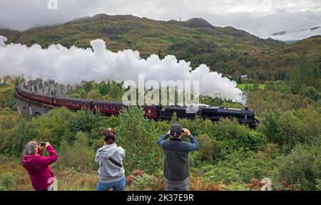 Tourist photograph the Jacobite Steam Train, Glenifinnan Viaduct, Lochaber, Scottish Highlands, Scotland, UK Stock Photo