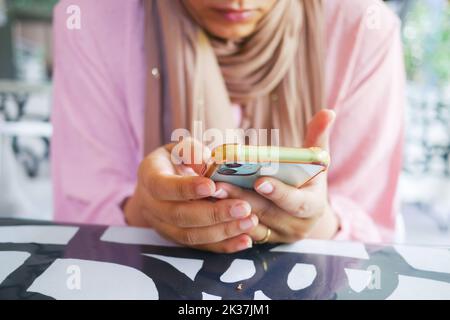women in pink color dress hand holding smart phone  Stock Photo