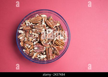 walnut in a bowl on red background  Stock Photo