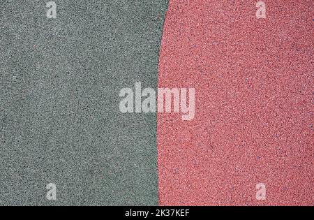 green and red pebbles texture background. park or playground flooring material. complementary colors Stock Photo