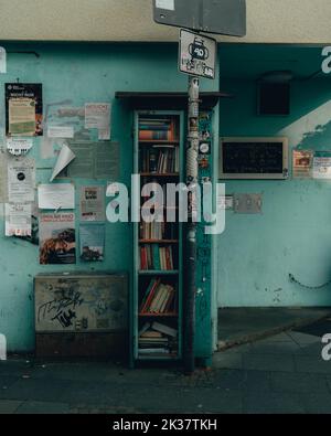 Typical vintage azure blue bookshelf on the streets of Nice, France. Retro toned. Mediterranean look. Stock Photo