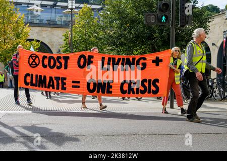 Bath, UK. 25th Sep, 2022. With PM Liz Truss signalling an acceleration of oil and gas extraction in the UK climate change protesters are pictured as they take part in a protest march through the centre of Bath. The protest organised by Extinction Rebellion was held in order to highlight how the cost of living crisis and the climate crisis are interlinked. Credit: Lynchpics/Alamy Live News