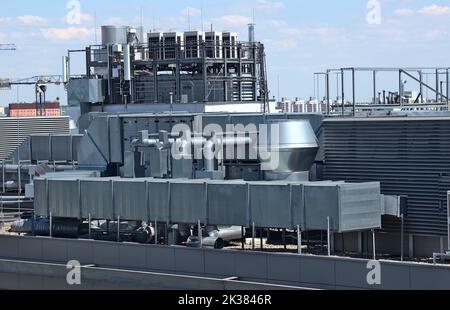 A ventilation system of a building located on the roof against a blue sky Stock Photo
