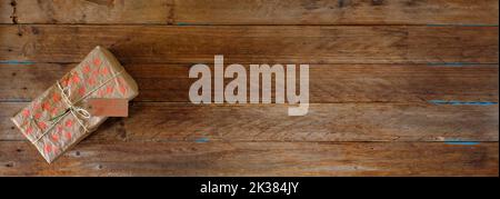Gift box with tag on wooden background, free copy space, panoramic Stock Photo