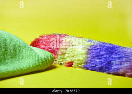The colored duster and cloth catch the dust found on household surfaces. Stock Photo