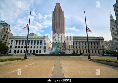 Cleveland, Ohio, USA - September 20, 2022: American flags fly at half mast in front of the Fountain Of Eternal Life at the Veterans' Memorial Plaza in Stock Photo