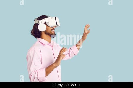 Smiling man in VR glasses enjoy modern technologies Stock Photo