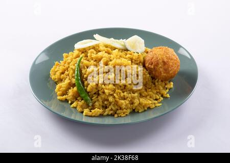 Bengali dish khichdi or khichuri made from a combination of lentils and rice along with Indian spices. in a mud bowl isolated on white background Beng Stock Photo