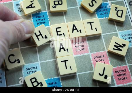 LETTER GAME TILES SPELLING HEAT/EAT RE COST OF LIVING CRISIS INCOMES BENEFITS HOUSEHOLD BUDGETS ETC UK Stock Photo