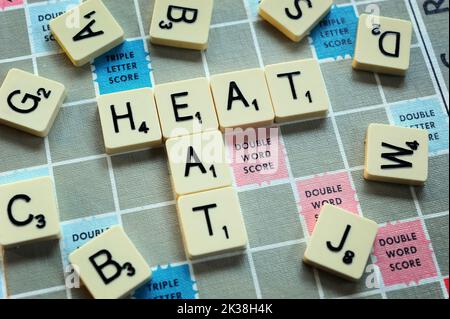 LETTER GAME TILES SPELLING HEAT/EAT RE COST OF LIVING CRISIS INCOMES BENEFITS HOUSEHOLD BUDGETS ETC UK Stock Photo