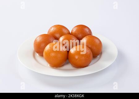 indian sweet gulab jamun closeup view.Sweet Gulab Jamun served in white ceramic bowl. Stock Photo