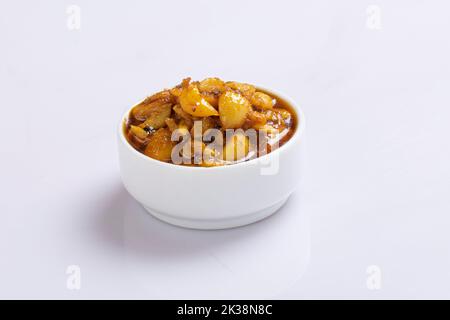 Fermented garlic cloves in a jar of honey, a rich source of probiotics, over a rustic wood background table. Selective focus with blurred background. Stock Photo