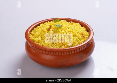 Bengali dish khichdi or khichuri made from a combination of lentils and rice along with Indian spices. in a mud bowl isolated on white background Stock Photo