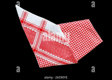 saudi men clothing accessory head scarf red shemagh closeup black background space for text luxury traditional Arabic men dressing Stock Photo