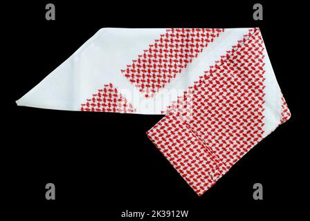 saudi men clothing accessory head scarf red shemagh closeup black background space for text luxury traditional Arabic men dressing Stock Photo