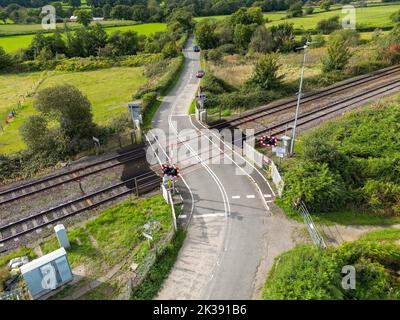 Bonvilston, Vale of Glamorgan, Wales - September 2022: Aerial view of a level crossing on the outskirts of Cardiff.
