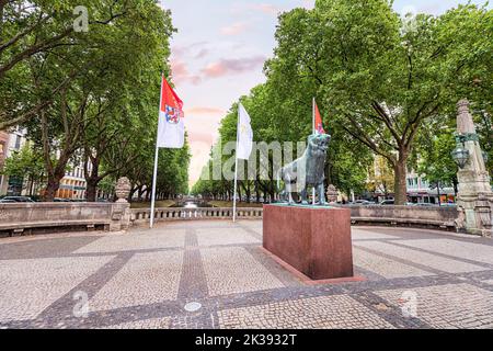 21 July 2022, Dusseldorf, Germany: statue of the lion - the symbol and coat of arms of Dusseldorf near the royal alley and canal Konigsallee