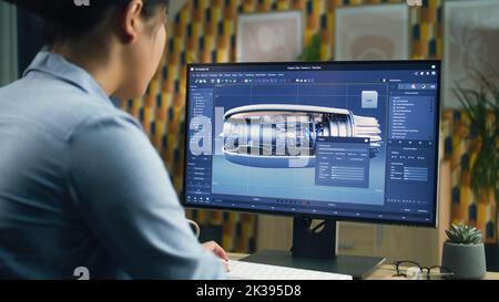 Female 3D designer using pc with professional program and creating 3D prototype of airplane turbine while working remotely at home office Stock Photo