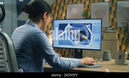 Asian female engineer drawing wind turbine 3D spare part in professional 3D modeling program on pc while working on project at home office Stock Photo