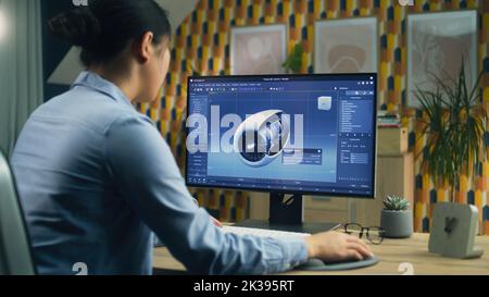Female 3D designer using pc with professional program and creating 3D prototype of airplane turbine while working remotely at home office Stock Photo