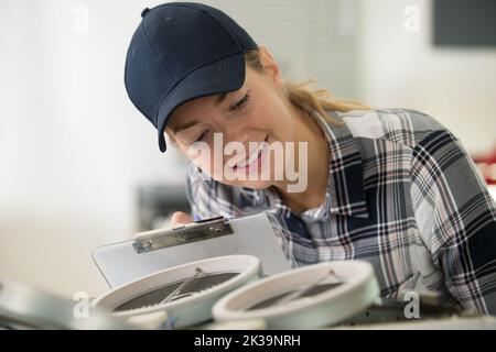woman installing a new hob in modern kitchen Stock Photo