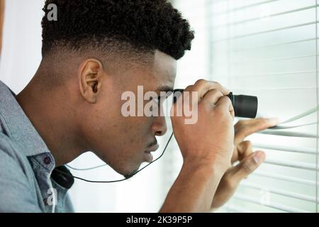 suspicious skeptic and confused man with binoculars Stock Photo