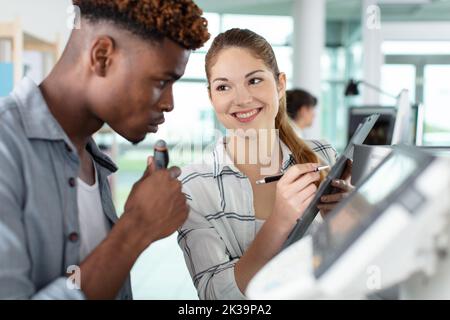 two designers working with printer in design studio Stock Photo