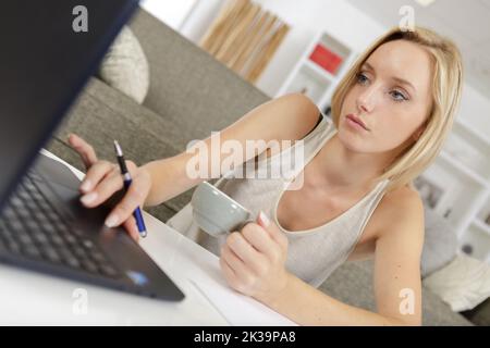 laptop and coffee cup in girls hands working Stock Photo