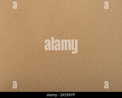 Brown paper texture. Textured background as a blank copy space. Cardboard structure with fine fiber details. Packaging material for a wrapping purpose Stock Photo