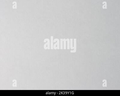 White cardboard texture as an abstract background. Fine structure in a white color. Detailed paper material with dust on it. Dirty surface of paper. Stock Photo