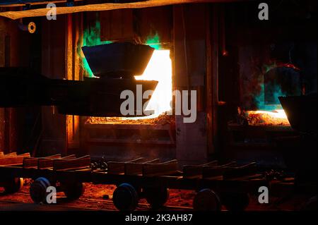 Loading ingots of remelt copper into reverberatory furnace Stock Photo ...