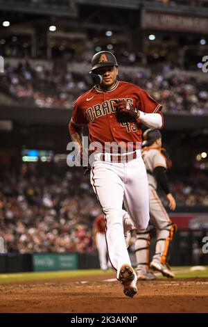 San Francisco Giants' Luis Gonzalez (51) scores a run behind Arizona  Diamondbacks catcher Jose Herrera on an error by infielder Sergio Alcantara  in the first inning during a baseball game, Wednesday, July