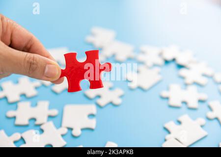 Hand put the last piece of jigsaw puzzle to complete the mission, Business solutions, success and strategy concept Stock Photo