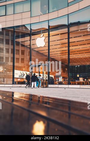 21 July 2022, Dusseldorf, Germany: Apple logo at the entrance to the store. Buying modern iphones and electronics. Phones and macintosh at the display Stock Photo
