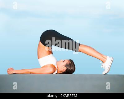 Shes Super Flexible A Young Woman Doing Yoga Stretches Outdoors Stock Shes Super Flexible A Young Woman Doing Yoga Stretches Outdoors Stock